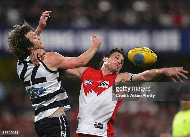 Jason Ball of the Swans contests the ball with Henry Playfair of the Cats during the AFL Semi Final match between the Sydney Swans and the Geelongs...