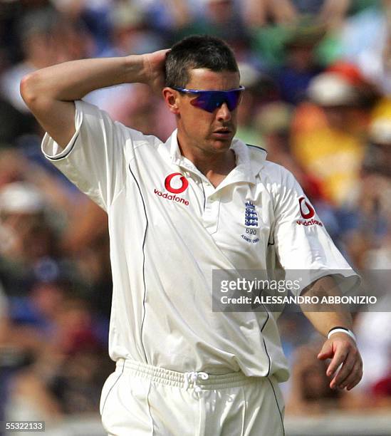 London, UNITED KINGDOM: England's Ashley Giles reacts after he gets hit for six runs by Australia's Justin Langer on the second day of the fifth and...