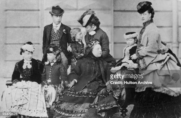 Queen Victoria and her family at Osborne House on the Isle of Wight, 1870. On the right is her daughter-in-law, later Queen Alexandra and behind is...