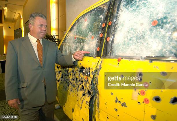 Gary Allen, President of Centigon, an Armor Holdings Company, points to vehicle door riddled with bullet fire September 9, 2005 in Washington, D.C....