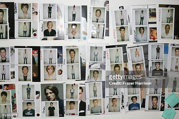Polaroids hang on a wall backstage at the Perry Ellis Spring 2006 fashion show during Olympus Fashion Week at Bryant Park September 9, 2005 in New...