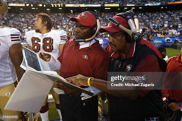 George Warhop meets with Bishop Harris of the San Francisco 49ers during the preseason game against the San Diego Chargers on September 1, 2005 at...