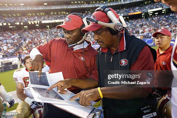 George Warhop meets with Bishop Harris of the San Francisco 49ers during the preseason game against the San Diego Chargers on September 1, 2005 at...