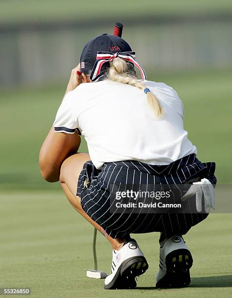 Natalie Gulbis of the USA lines up a putt on the 10th green, while the metal spikes on her shoes are seen during the four-ball matches in the 2005...