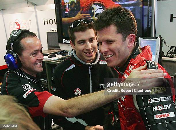 Garth Tander of the HSV Dealer Team is congratulated by teammates after taking pole postion during qualifying for the Betta Electrical 500, which is...