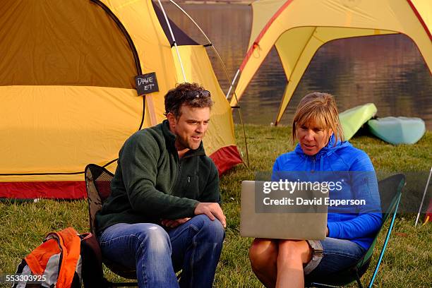 corporate camping retreat by mountain lake - experiential vacations stock pictures, royalty-free photos & images