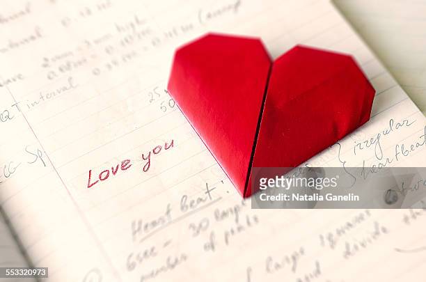 paper heart and open notebook - origami alphabet stock pictures, royalty-free photos & images