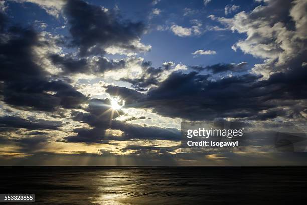 rays of sunshine through the clouds - isogawyi stock pictures, royalty-free photos & images