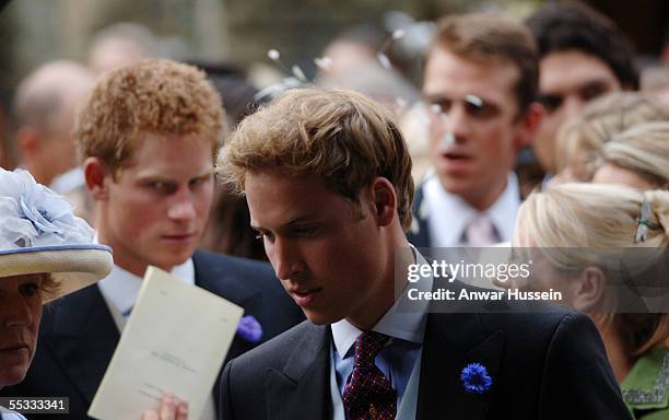 Prince William and Prince Harry leave the wedding of Camilla, Duchess of Cornwall's son, Tom Parker-Bowles, to Sara Buys on September 10, 2005 in...