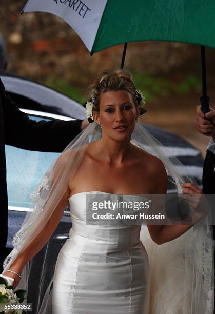 Sara Buys shelters under an umbrella as she arrives for her wedding to Tom Parker-Bowles, son of Camilla, Duchess of Cornwall, at St. Nicholas's...