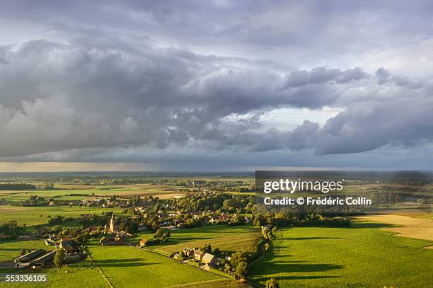 small village at sunset - storm cloud stock pictures, royalty-free photos & images