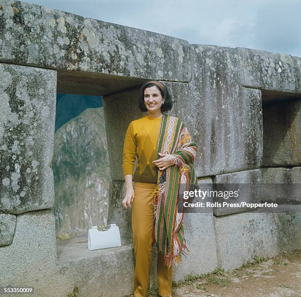 Carmen Franco, daughter of General Francisco Franco of Spain, pictured standing beside large carved interlocking stones at the Inca settlement of...