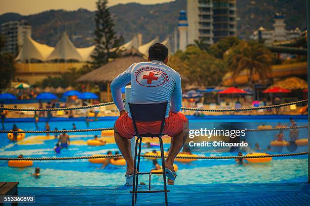 lifeguard watching swimmers in a water park - backstube stock pictures, royalty-free photos & images