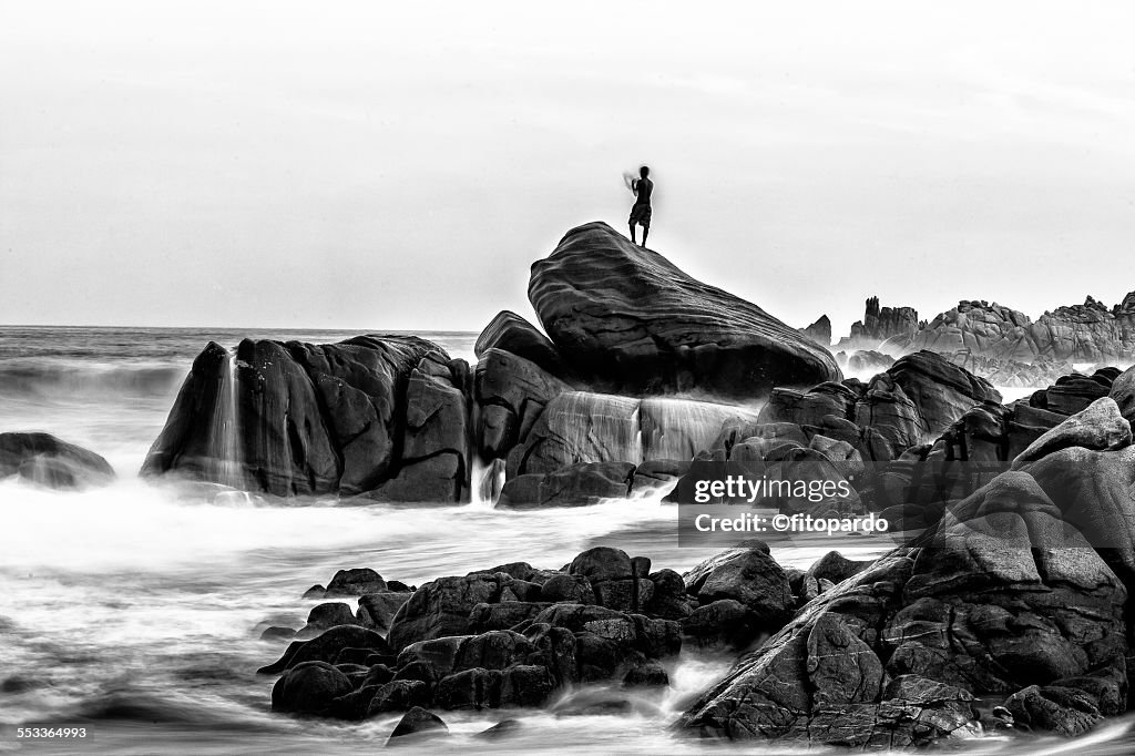 Man silhuetted against the horizon in a seascape