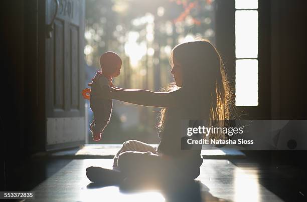 playing with her baby - doll stock pictures, royalty-free photos & images