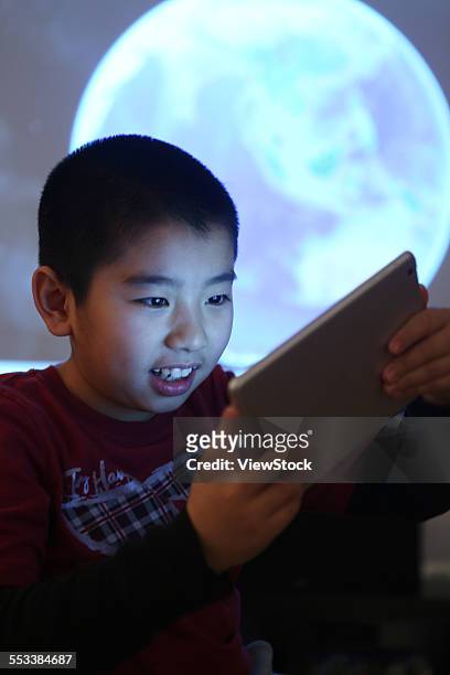 the boy in the use of flat panel computer - boy looking up stock pictures, royalty-free photos & images