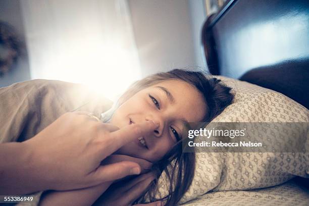 mother waking up daughter - child and unusual angle stock-fotos und bilder