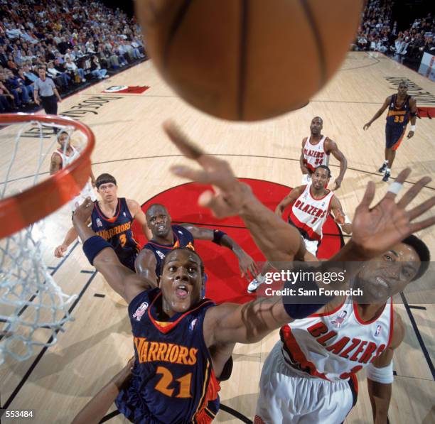 Forward Danny Fortson of the Golden State Warriors and guard Scottie Pippen of the Portland Trail Blazers attempts to rebound the ball during the NBA...