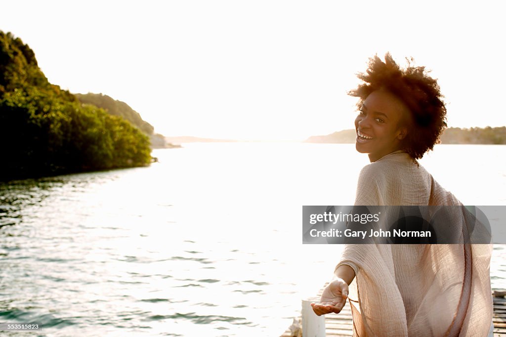 Happy young woman looking back and laughing.