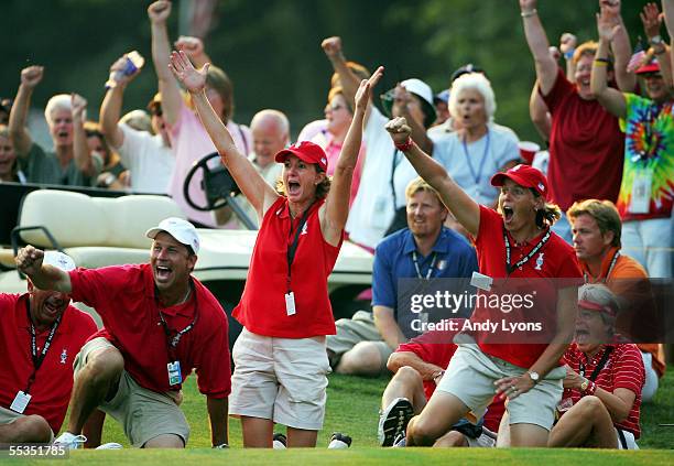 Team members Beth Daniel, Wendy Ward and caddie Greg Johnston celebrate around the 18th hole during the fourball matches during the second round of...