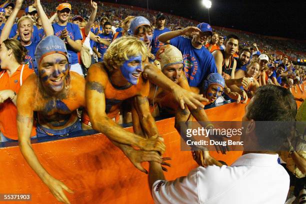 Head coach Urban Meyer of the University of Florida Gators gets congratulated by Gator fans after defeating the Louisiana Tech Bulldogs at Ben Hill...
