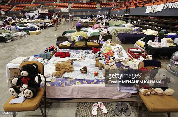 Teddy bear stuffed toys are place on a bed by Hurricane Katrina evacuees at the civil center in Lake Charles, Louisiana, 10 September 2005, were some...