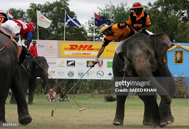 Angad Kalan of Chivas Regal Scotland leans on his elephant to get the ball in control during extra time of the 5th King's Cup Elephant Polo...