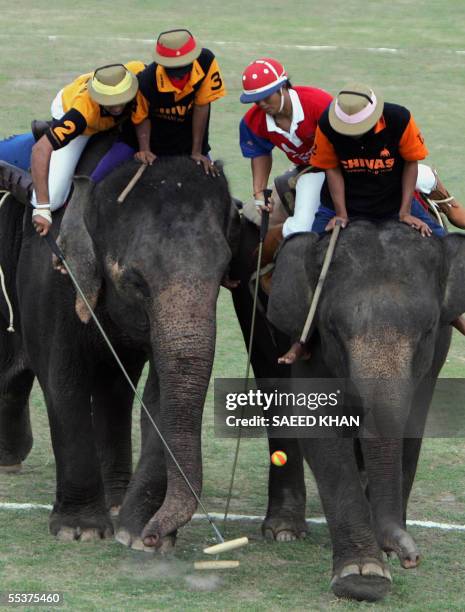 Angad Kalan Chivas regal Scotland and Omsin Pratumalee of Mullis Capital lean on their elephants to get the ball in control in the final of the 5th...