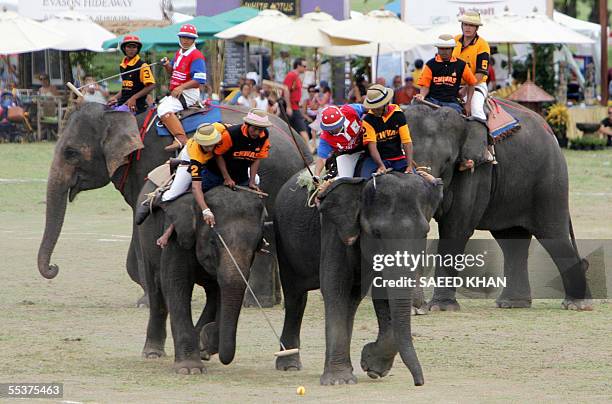 Angad Kalan Chivas regal Scotland and Omsin Pratumalee of Mullis Capital lean on their elephants to get the ball in control in the final of the 5th...