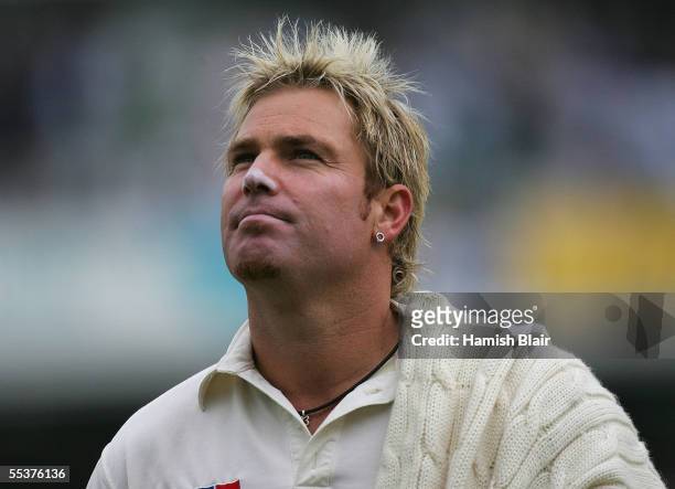 Shane Warne of Australia leaves the field as bad light stops play during day four of the Fifth npower Ashes Test between England and Australia played...
