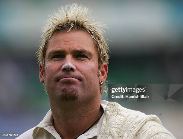 Shane Warne of Australia leaves the field as bad light stops play during day four of the Fifth npower Ashes Test between England and Australia played...