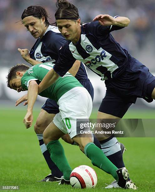 Niko Kovac with Marko Pantelic of Berlin and Andres D'Alessandro of Wolfsburg challenge for the ball during the Bundesliga match between Hertha BSC...