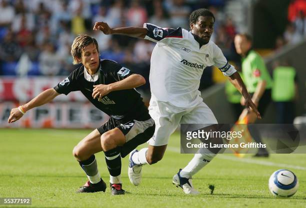 Jay Jay Okocha of Bolton battles for the ball with Morten Gamst Pedersen of Blackburn during the Barclays Premiership match between Bolton Wanderers...