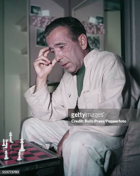 American actor Humphrey Bogart pictured playing a game of chess in 1955.