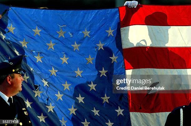 Flag bearers hold onto a U.S. Flag at Ground Zero September 11, 2005 in New York City. This is the fourth anniversary of the September 11th attacks.