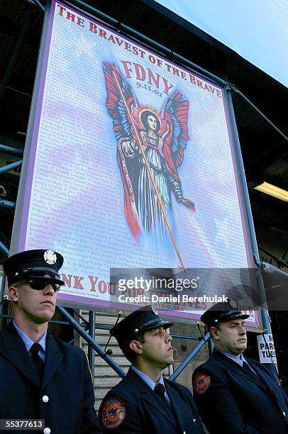 Members of the New York City Fire Department stand in silence at Ground Zero September 11, 2005 in New York City. This is the fourth anniversary of...