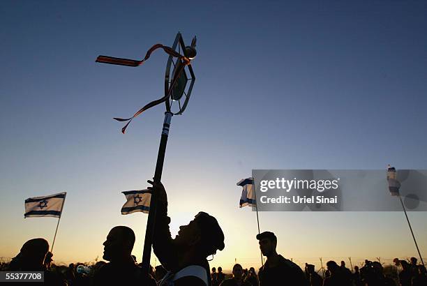 Israeli soldiers take part in a flag-lowering ceremony as they prepare to withdraw from the army headquarters September 11, 2005 in Gush Katif in the...