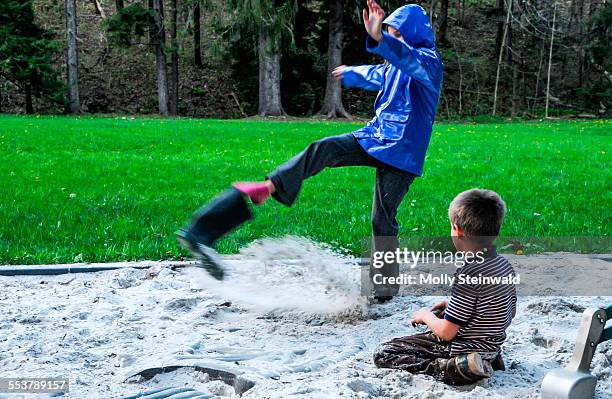 a girl kicks sand out from her boot at laurel hill state park pa. - molly steinwald stock-fotos und bilder