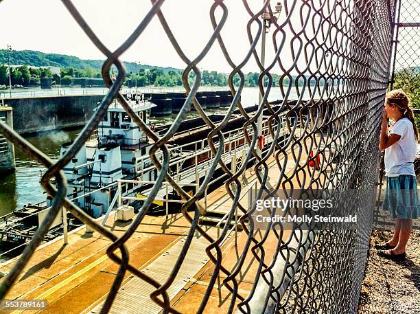 a girl watches a tug boat at a locks along the ohio river in pittsburgh pa. during the spring - molly steinwald stock pictures, royalty-free photos & images