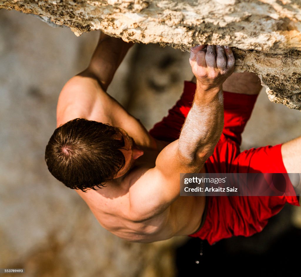 Detail of a climber grabbing a hold as he is climbing a psicobloc route in Kalymnos, Greece.