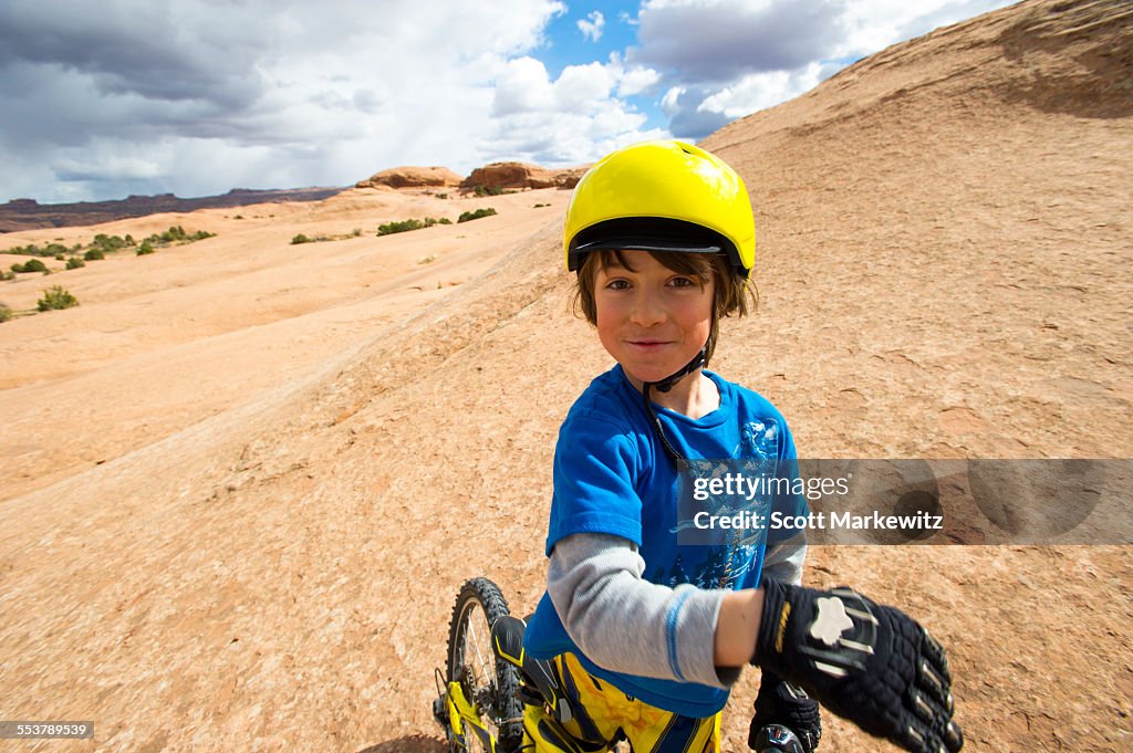 Kid Sitting on his Mountain Bike in Desert