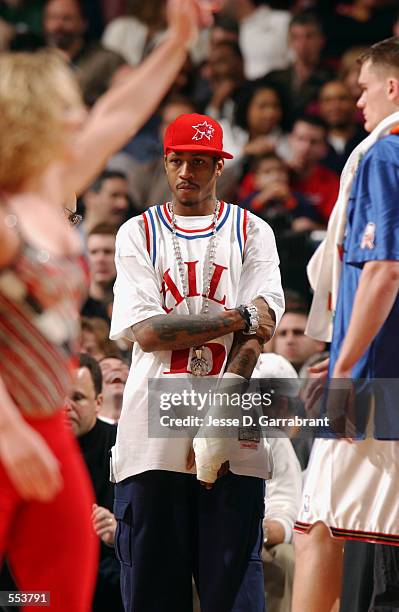 Guard Allen Iverson of the Philadelphia 76ers stands in street clothes during the NBA game against the Phoenix Suns at First Union Center in...