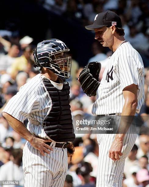 Starting pitcher Randy Johnson of the New York Yankees talks to his catcher John Flaherty during the game against the Boston Red Sox on September 11,...