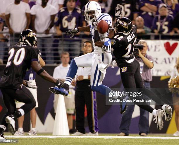 Cornerback Samari Rolle of the Baltimore Ravens breaks up a pass intended for wide receiver Reggie Wayne of the Indianapolis Colts as safety Ed Reed...