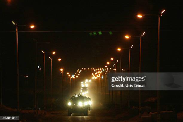 An Israeli armored convoy leaves the through the Kissufim crossing as Israel ends its 38-year long occupation of the Palestinian territory early...