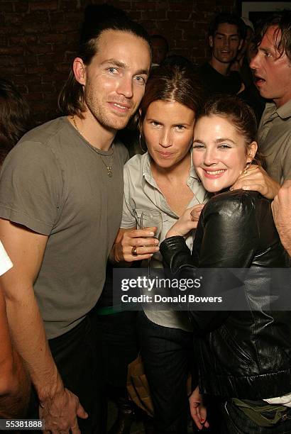 Designer David Neville, make-up artist Gucci and actress Drew Barrymore pose at the Rag & Bone Spring 2006 after party during Olympus Fashion Week at...