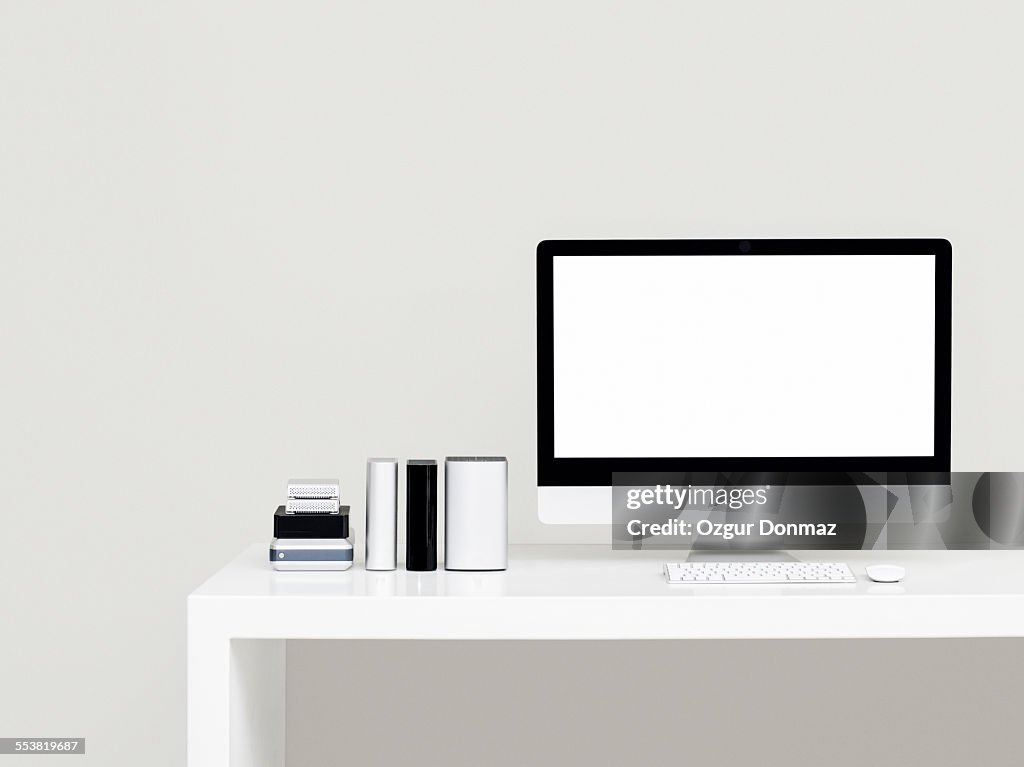 Modern desk with computer and hard drives