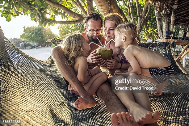 family relaxing in hammock. - travel family imagens e fotografias de stock