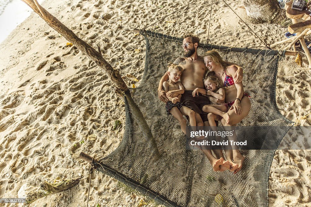 Family relaxing in hammock.