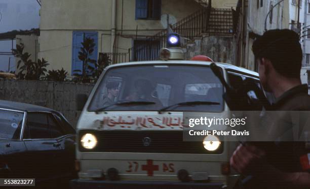 Red Cross ambulance drives past soldiers amid the destruction and damage at the scene of the suicide bombing of the American Embassy, Beirut,...